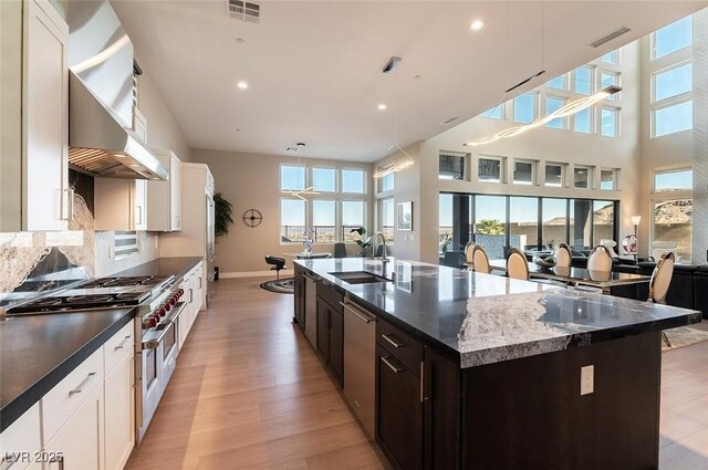 5436 Succulent Rose Dr, Las Vegas, NV 89135 - kitchen featuring visible vents, appliances with stainless steel finishes, a sink, open floor plan, and light wood-style flooring