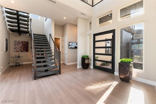 5436 Succulent Rose Dr, Las Vegas, NV 89135 - foyer with baseboards, light wood finished floors, a high ceiling, and stairway