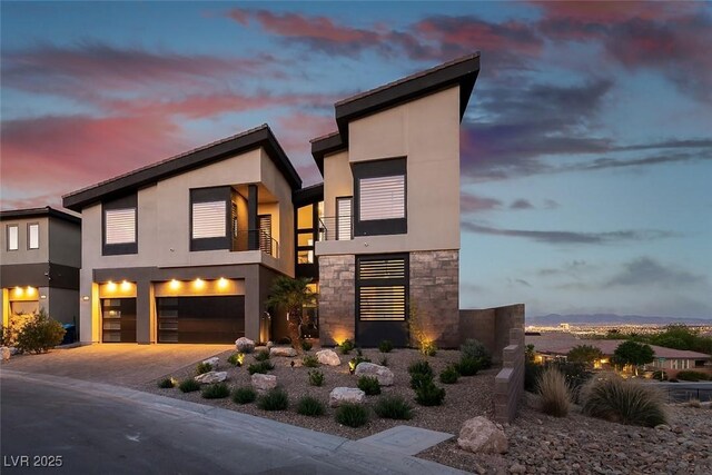 5436 Succulent Rose Dr, Las Vegas, NV 89135 - modern home featuring a garage, stucco siding, driveway, and stone siding