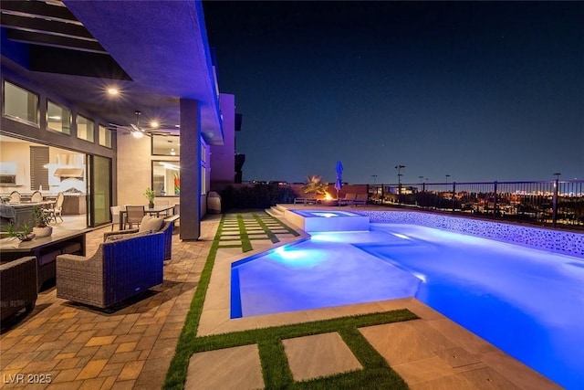5436 Succulent Rose Dr, Las Vegas, NV 89135 - pool at twilight featuring a patio, a pool with connected hot tub, and fence