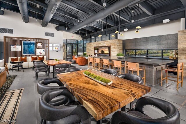 5436 Succulent Rose Dr, Las Vegas, NV 89135 - dining room featuring a community bar, a high ceiling, beam ceiling, and visible vents
