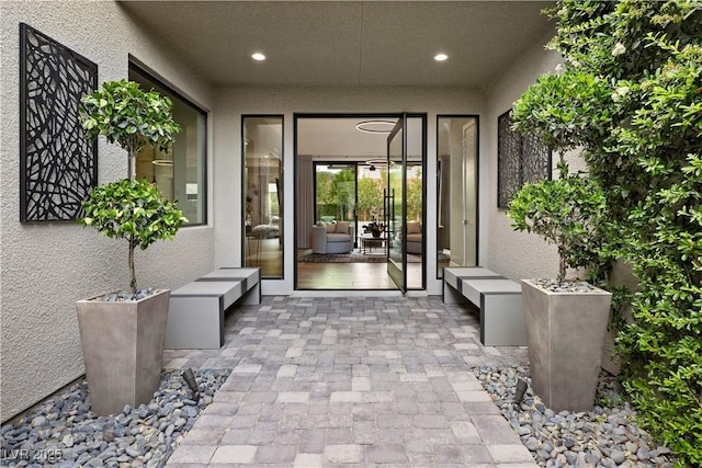 property entrance with stucco siding