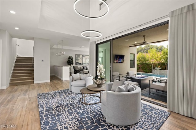 living area with ceiling fan, stairs, recessed lighting, baseboards, and wood finished floors