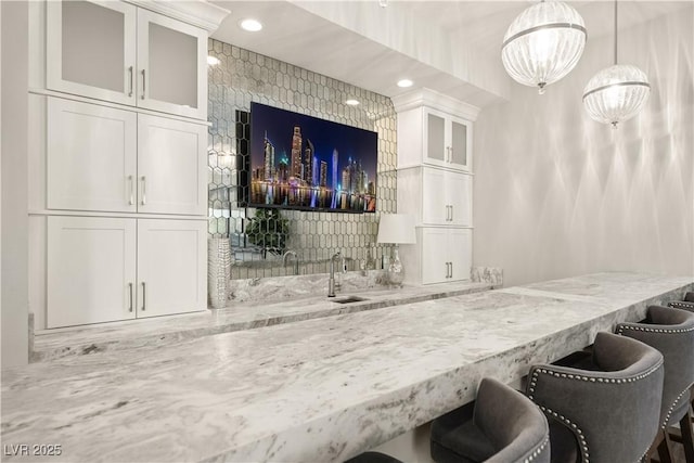 bar featuring recessed lighting, an inviting chandelier, hanging light fixtures, and bar