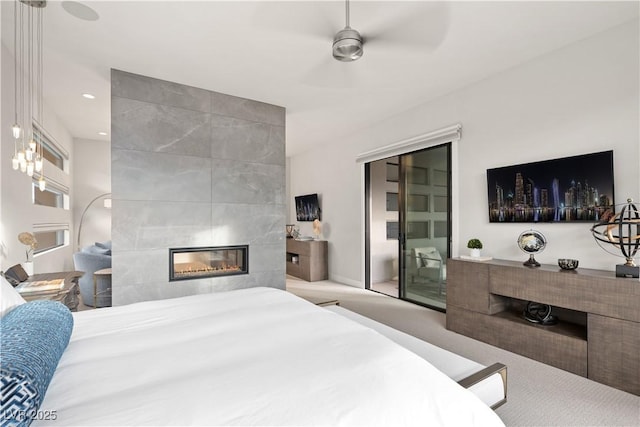 bedroom with a tiled fireplace, ceiling fan, carpet flooring, and recessed lighting
