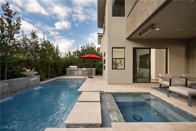 pool with area for grilling, an outdoor kitchen, an in ground hot tub, and a patio area