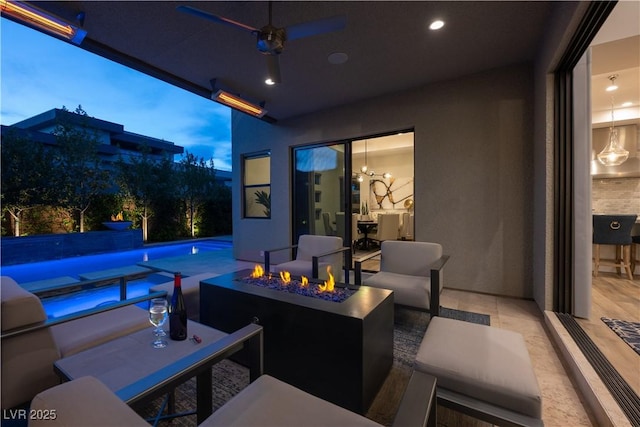 view of patio with a ceiling fan, an outdoor fire pit, and an outdoor pool