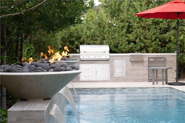pool featuring an outdoor fire pit, area for grilling, and a grill