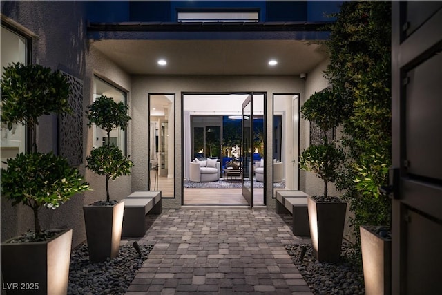 property entrance with a patio area and stucco siding