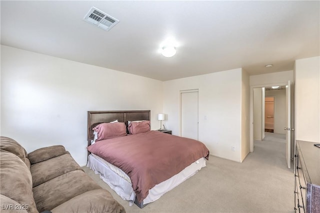 bedroom with visible vents and light carpet
