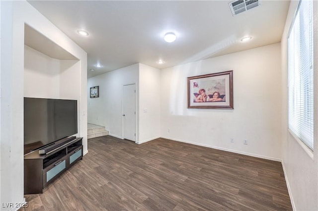 unfurnished living room featuring visible vents, recessed lighting, dark wood finished floors, and baseboards