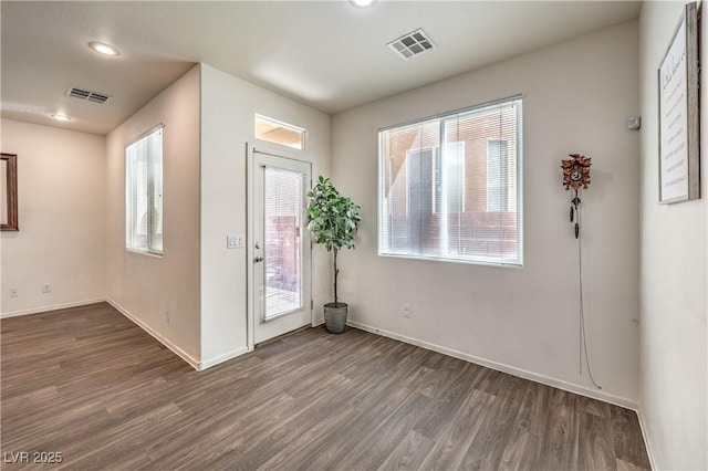 entrance foyer featuring visible vents, baseboards, and wood finished floors