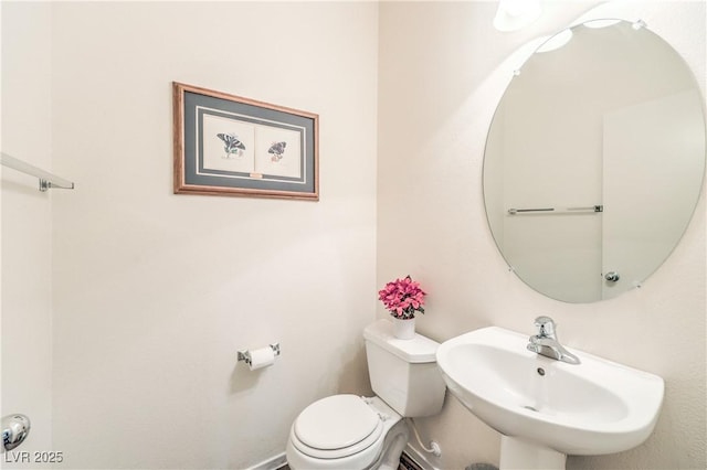 bathroom featuring toilet and a sink