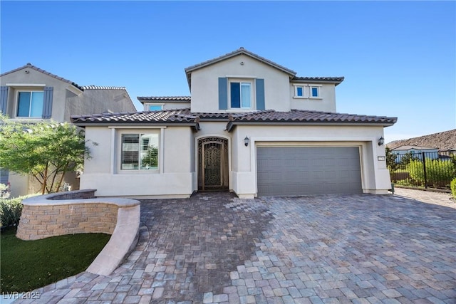 12705 Coastline Shadow St, Las Vegas, NV 89141 - mediterranean / spanish-style house with a tile roof, stucco siding, an attached garage, and decorative driveway