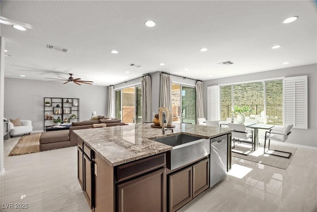 12705 Coastline Shadow St, Las Vegas, NV 89141 - kitchen featuring dishwasher, a kitchen island with sink, recessed lighting, light stone counters, and a ceiling fan