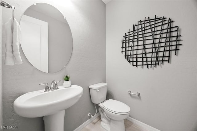 12705 Coastline Shadow St, Las Vegas, NV 89141 - bathroom featuring toilet, baseboards, and a sink