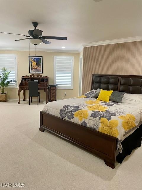 carpeted bedroom with baseboards, ornamental molding, and a ceiling fan