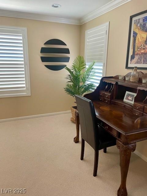 carpeted home office featuring crown molding and baseboards