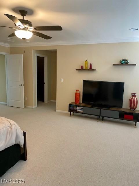 bedroom with crown molding, baseboards, light carpet, and ceiling fan