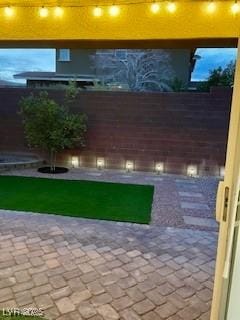 view of yard with a patio and fence