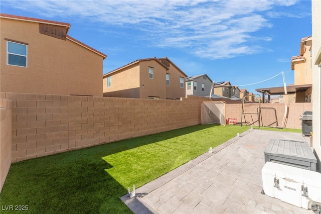 view of yard with a patio, a fenced backyard, and a residential view