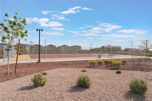 view of jungle gym featuring fence and community basketball court