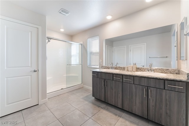 bathroom with visible vents, a sink, tile patterned floors, and a shower stall