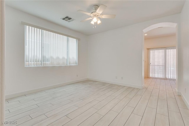 8824 Charm Canyon Ave, Las Vegas, NV 89178 - unfurnished room featuring visible vents, arched walkways, a ceiling fan, and a wealth of natural light