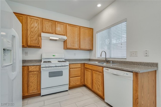 8824 Charm Canyon Ave, Las Vegas, NV 89178 - kitchen featuring brown cabinets, a sink, under cabinet range hood, recessed lighting, and white appliances