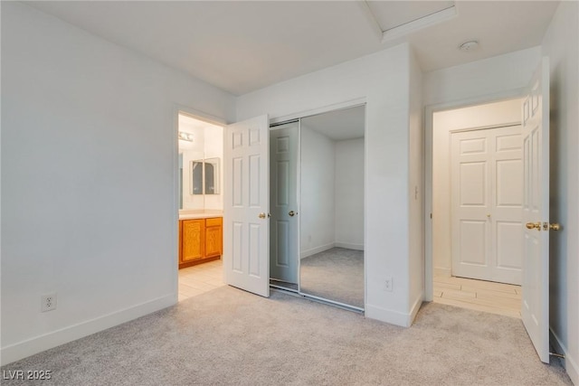 8824 Charm Canyon Ave, Las Vegas, NV 89178 - unfurnished bedroom with connected bathroom, baseboards, light colored carpet, and a closet