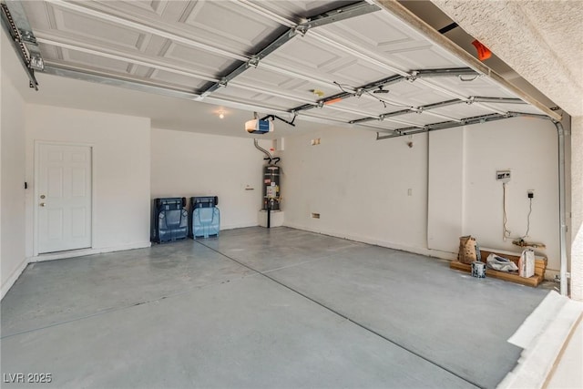 8824 Charm Canyon Ave, Las Vegas, NV 89178 - garage featuring secured water heater, baseboards, and a garage door opener