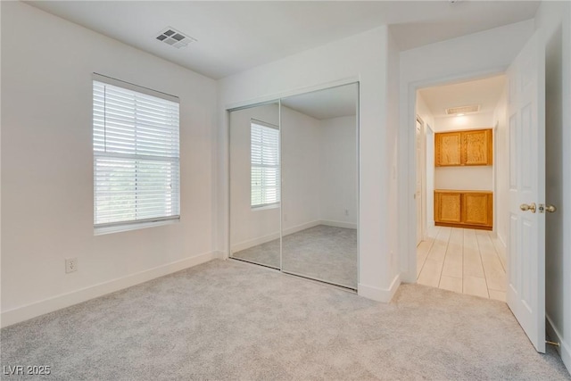 8824 Charm Canyon Ave, Las Vegas, NV 89178 - unfurnished bedroom with baseboards, carpet, a closet, and visible vents
