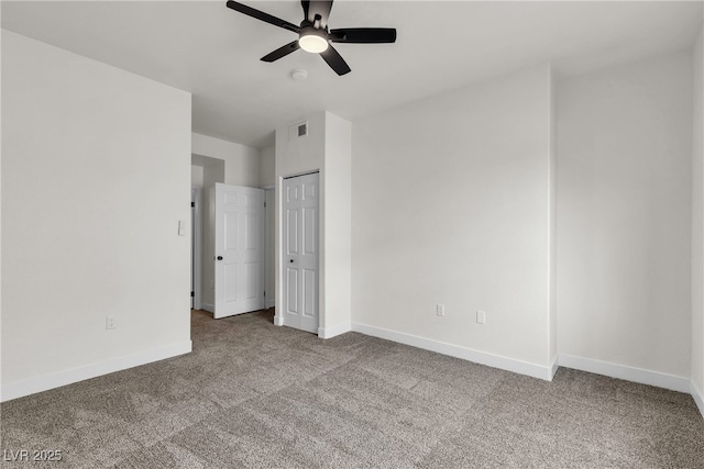 unfurnished bedroom with carpet floors, baseboards, and visible vents