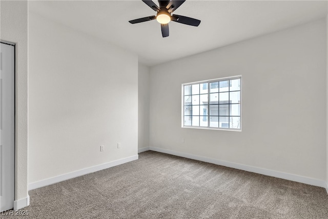 empty room with baseboards, carpet, and a ceiling fan