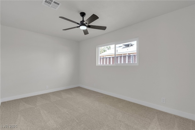 unfurnished room featuring visible vents, baseboards, and light colored carpet