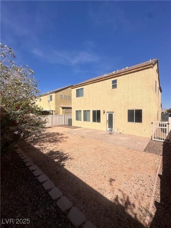 back of property with a patio, a fenced backyard, and stucco siding
