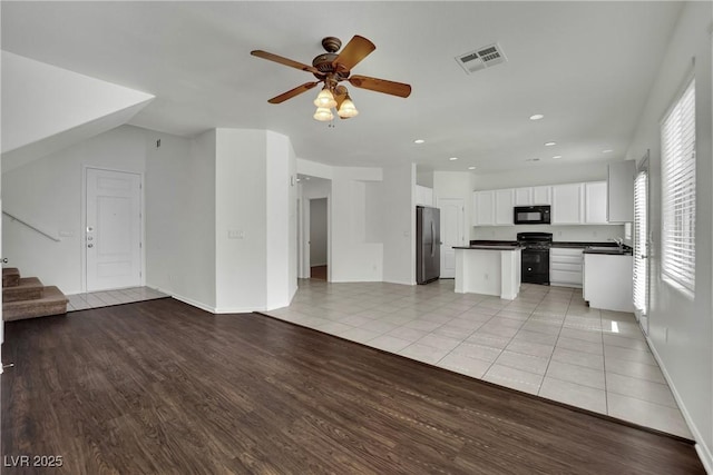 6525 Bismark Hills St, North Las Vegas, NV 89084 - unfurnished living room with a sink, stairway, ceiling fan, light tile patterned flooring, and recessed lighting