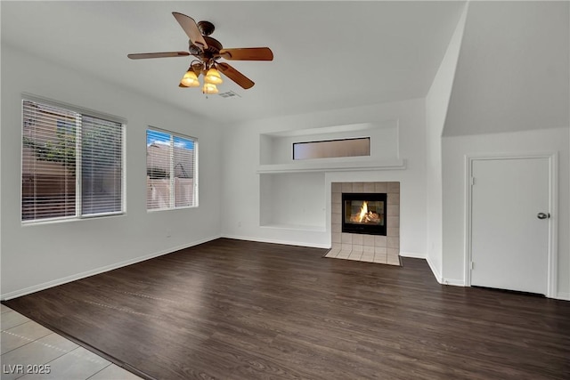 6525 Bismark Hills St, North Las Vegas, NV 89084 - unfurnished living room with wood finished floors, ceiling fan, a fireplace, baseboards, and built in features