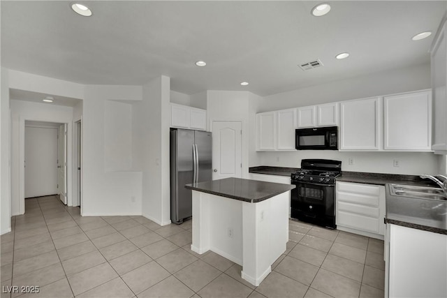 6525 Bismark Hills St, North Las Vegas, NV 89084 - kitchen with black appliances, a sink, dark countertops, recessed lighting, and a center island