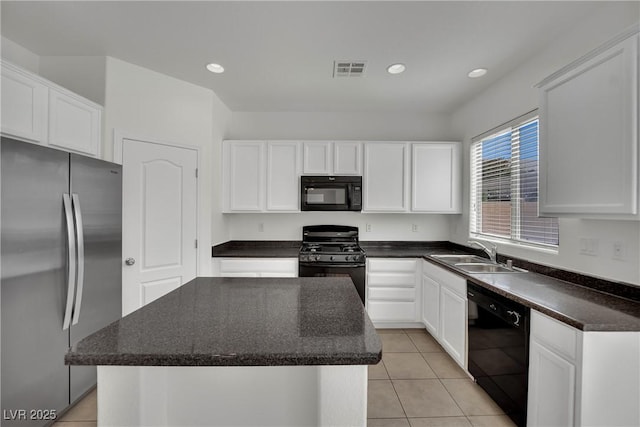 6525 Bismark Hills St, North Las Vegas, NV 89084 - kitchen with black appliances, a sink, a center island, white cabinets, and recessed lighting