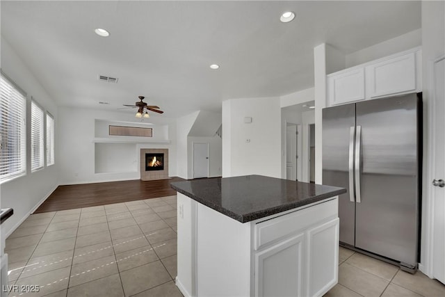 6525 Bismark Hills St, North Las Vegas, NV 89084 - kitchen with freestanding refrigerator, light tile patterned floors, ceiling fan, a fireplace, and recessed lighting