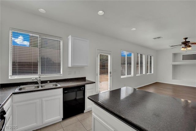 6525 Bismark Hills St, North Las Vegas, NV 89084 - kitchen with black dishwasher, a sink, dark countertops, built in features, and open floor plan