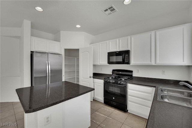 6525 Bismark Hills St, North Las Vegas, NV 89084 - kitchen featuring black appliances, a sink, white cabinets, light tile patterned floors, and recessed lighting