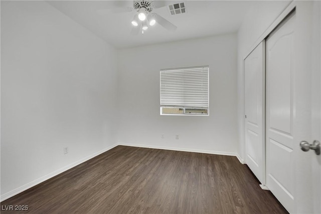 6525 Bismark Hills St, North Las Vegas, NV 89084 - unfurnished bedroom featuring dark wood finished floors, baseboards, a closet, and a ceiling fan