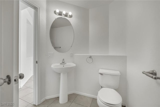 6525 Bismark Hills St, North Las Vegas, NV 89084 - half bath featuring tile patterned floors, toilet, baseboards, and a sink