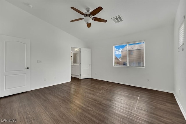 6525 Bismark Hills St, North Las Vegas, NV 89084 - unfurnished bedroom with lofted ceiling, dark wood-style floors, baseboards, ensuite bath, and ceiling fan