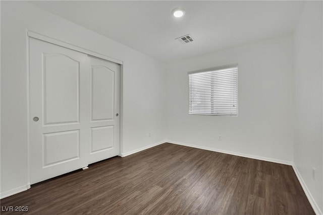 6525 Bismark Hills St, North Las Vegas, NV 89084 - unfurnished bedroom featuring dark wood-style flooring, baseboards, and a closet