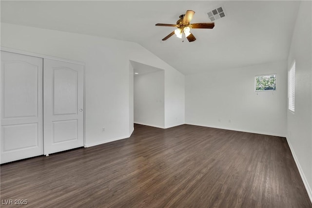 6525 Bismark Hills St, North Las Vegas, NV 89084 - unfurnished bedroom featuring lofted ceiling, dark wood-type flooring, a closet, baseboards, and a ceiling fan