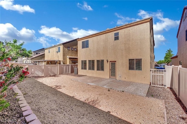 6525 Bismark Hills St, North Las Vegas, NV 89084 - back of property featuring stucco siding, a patio area, and a fenced backyard