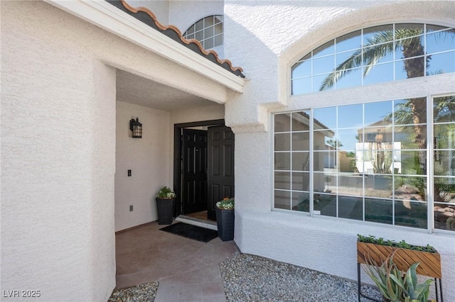 entrance to property with stucco siding